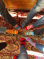 Artisan wool socks in vibrant colors, hand-knit for warmth.