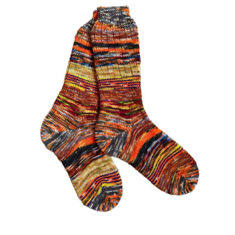 Scrappy wool socks in vibrant colors, handknit for warmth.