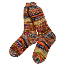 Colorful scrappy wool socks displayed in a cozy setting.